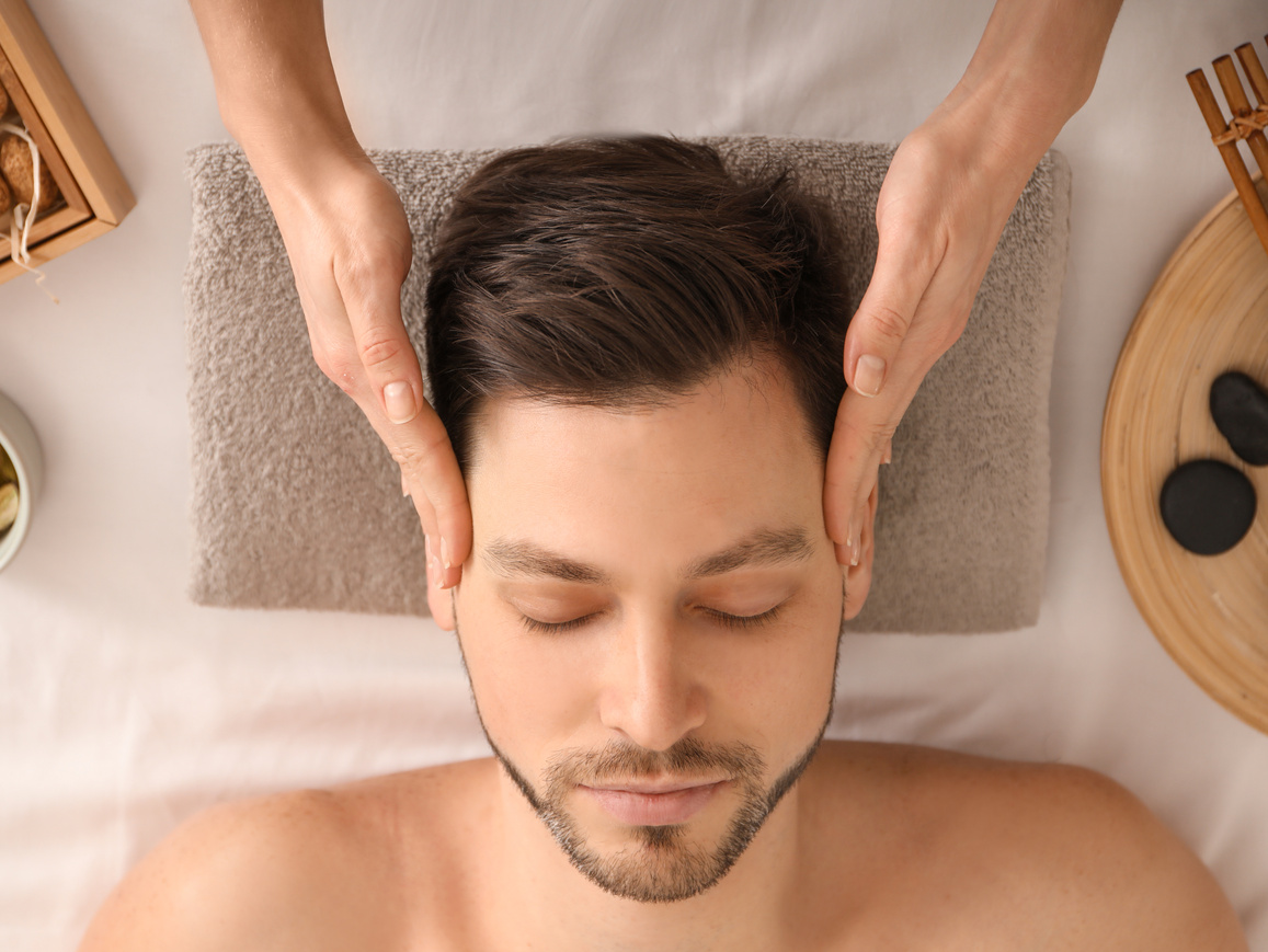 Handsome Man Having Head Massage in Spa Salon